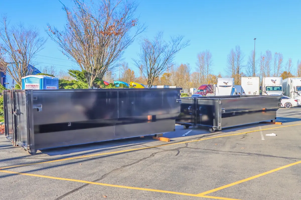 Professional dumpster rental service with roll-off container on residential driveway in Courtland